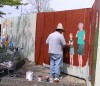 Painting the fences of White Rock, Canada